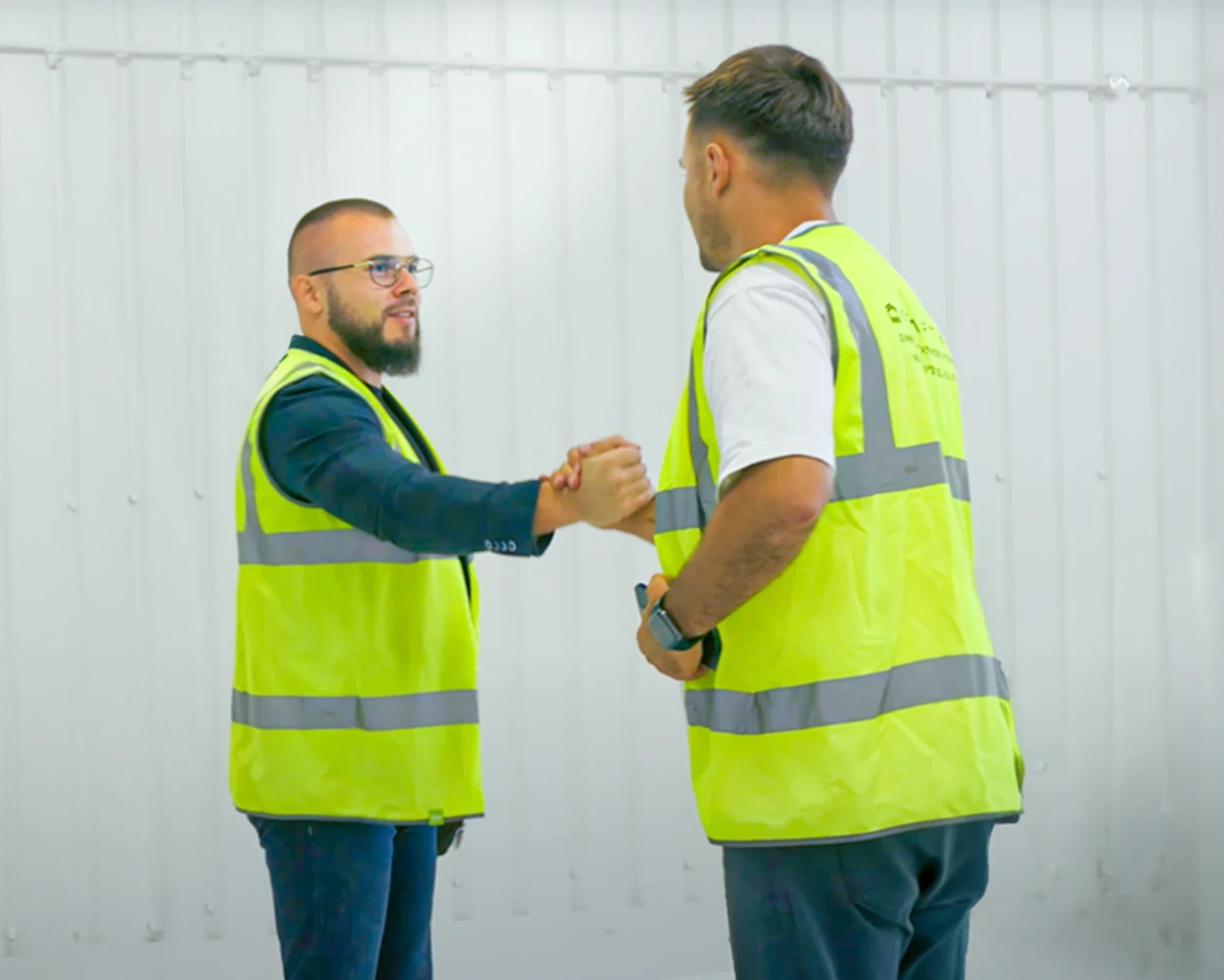 Sviat Jay shaking hands with a builder on site